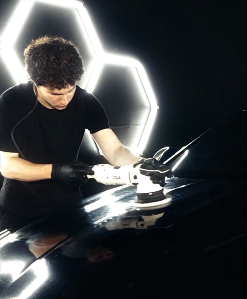 Regency Auto Protection technician machine-polishing a car hood during paint correction